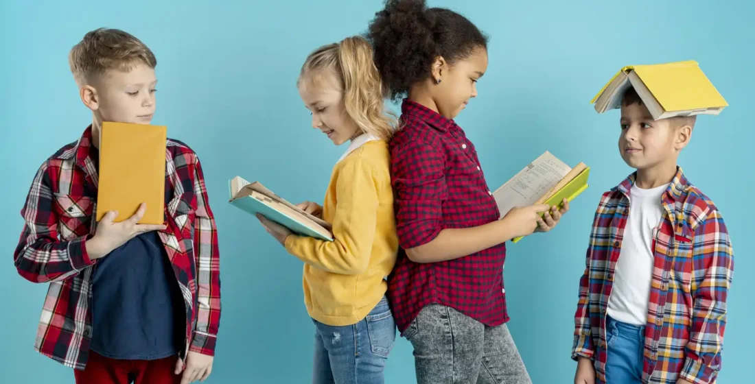 A diverse group of children sitting together and reading books in a cozy, bright classroom at LAE Kids in Madrid.